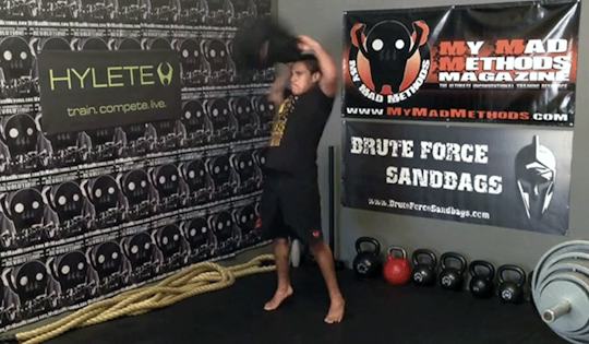 exercise sandbag half moon snatch