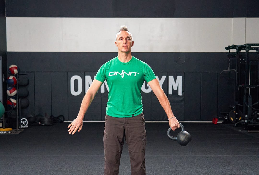 Man doing kettlebell around the world exercise.